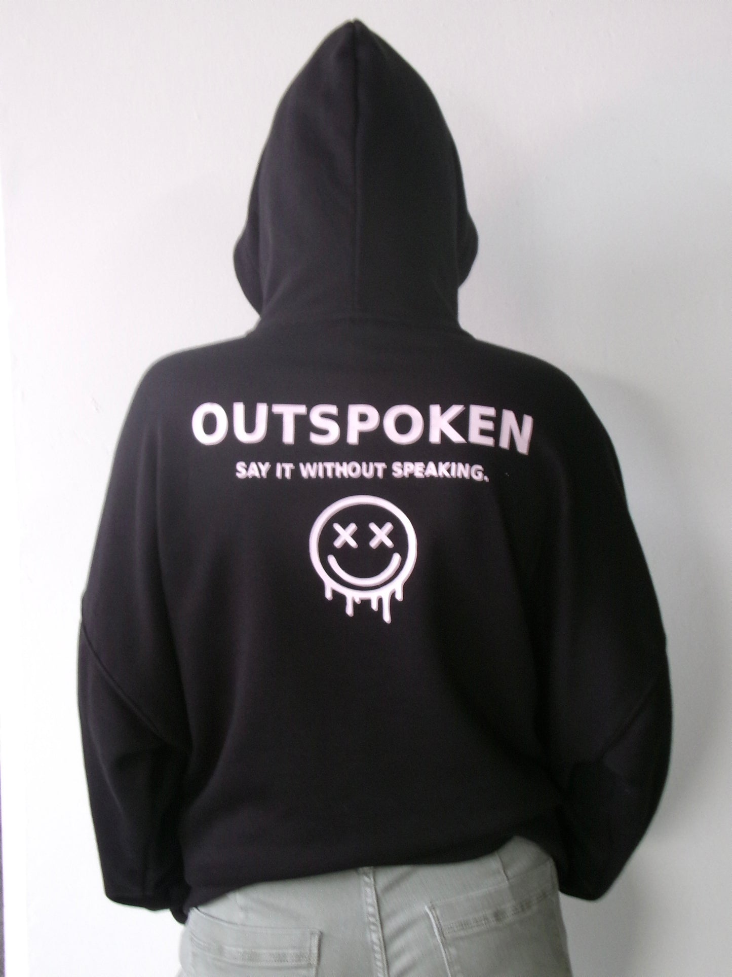 Back of the OUTSPOKEN Signature Hoodie featuring the Say It Without Speaking design